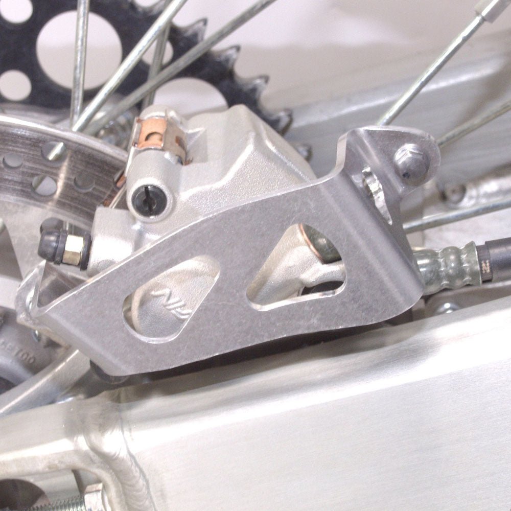 WORKS CONNECTION REAR BRAKE CALIPER GUARD YAMAHA YZ125/250 06 - 21, YZ250/450F 06 - 20, YZ250FX 15 - 21, YZ450FX 16 - 20, WR250F 06 - 23, WR450F 06 - 25 - ACE Race Shop
