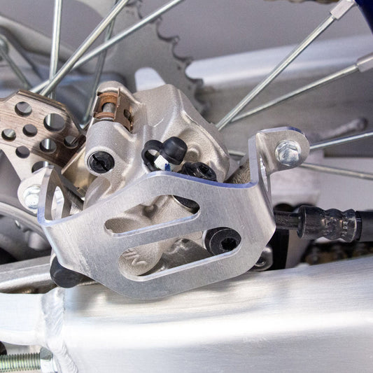 WORKS CONNECTION REAR BRAKE CALIPER GUARD YAMAHA YZ125/250 22 - 25, YZ12/250X 23 - 25, YZ250F 21 - 25, YZ250FX 22 - 25, YZ450F 20 - 25, YZ450FX 21 - 25 - ACE Race Shop